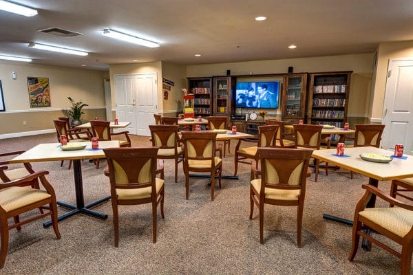 Chairs and tables in front of a tv in the The Chateau Gardnerville media room
