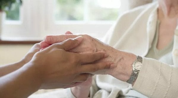 McLeod Home Care caregivers hands holding senior womans hands