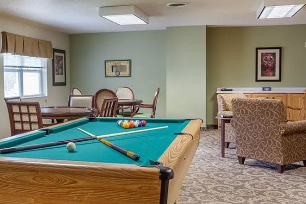 Green felt pool table in the Dimensions Living Stevens Point buillards and game room