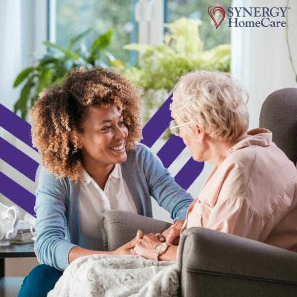 Synergy HomeCare of Birmingham caregiver smiling and talking with elderly woman