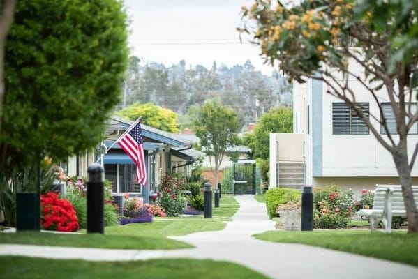 Walkway with houses and an American Flag at Redwood Terrace