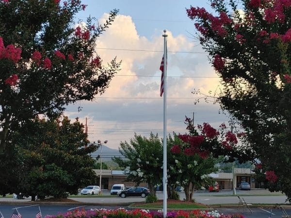 American flag and colorful trees in front of NHC Place, AnnistonNHC Place, Anniston