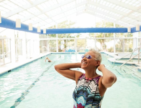 Woman smiling while exiting the Linden Ponds indoor pool