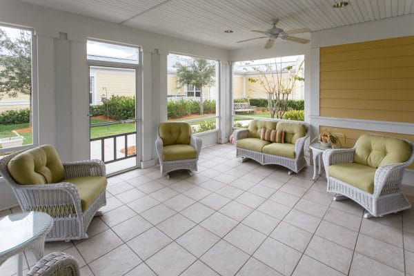Outdoor seating on white wicker furniture on The Brennity at Tradition patio