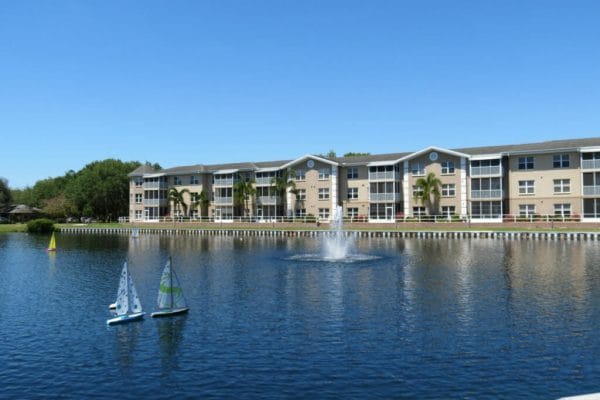 Large pond with sailboats in front on the Sunnyside Village Garden apartments