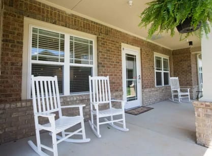 White rocking chairs on the Chatham Ridge Assisted Living porch