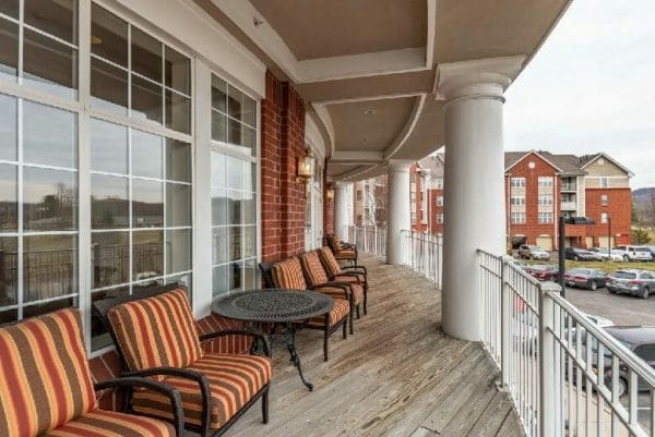 Chairs on a Elison Independent & Assisted Living of Maplewood balcony overlooking the property