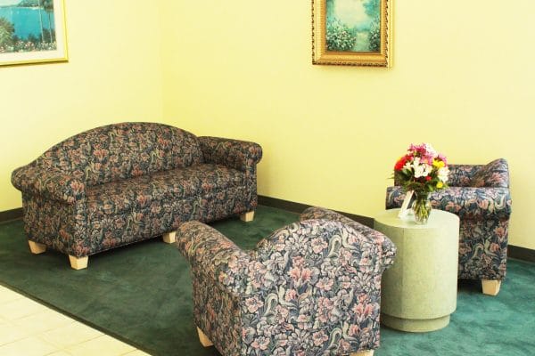 Terrace Health and Rehabilitation Center residence lounging area with matching sofa and overstuffed arm chairs