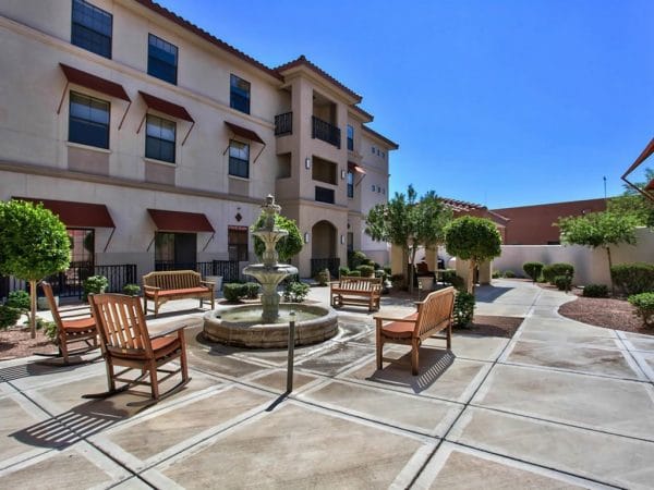 The Woodmark at Sun City community courtyard with water fountain and seating areas
