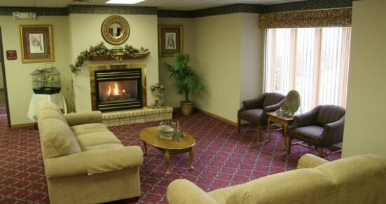 Community living room and fireplace in Hay Creek Lodge