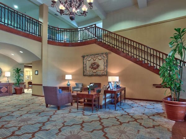 Grand staircase leading down into The Woodmark at Sun City lobby and foyer