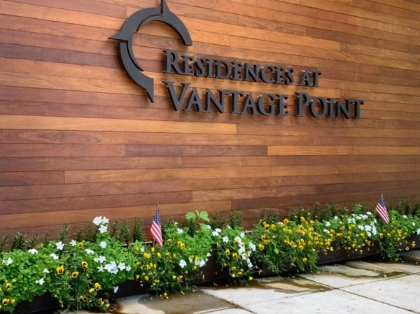 Residences at Vantage Point welcome sign made of wood slats