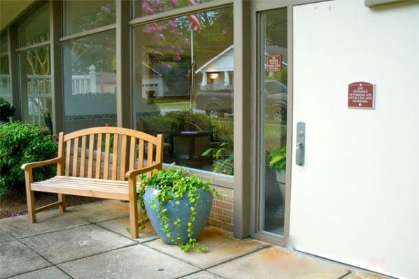 Front door and bench at Magnolia Manor of Greenville