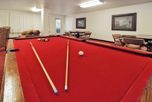 Red felt pool table in the Andover Place billiards room