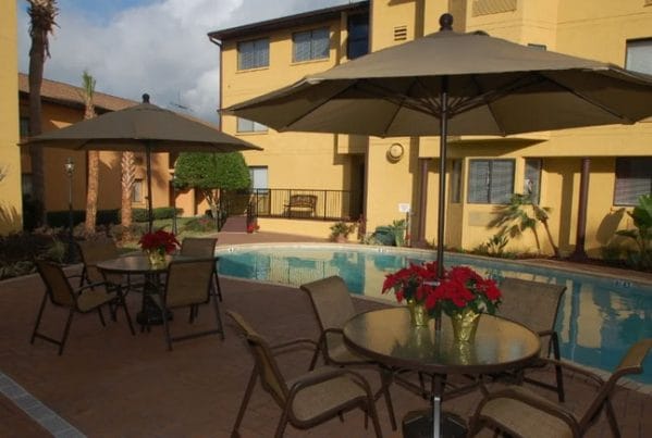 Swimming pool and umbrella tables at Grand Villa of Altamonte Springs