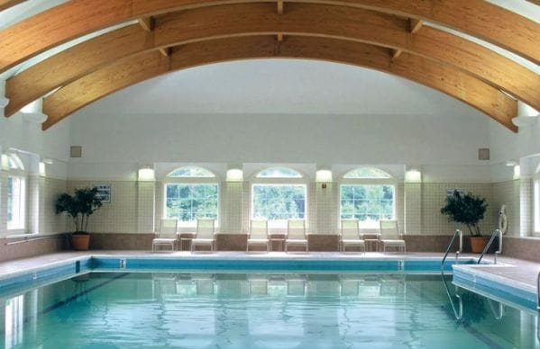 Indoor swimming pool and structured wooden beams in Meadow Ridge
