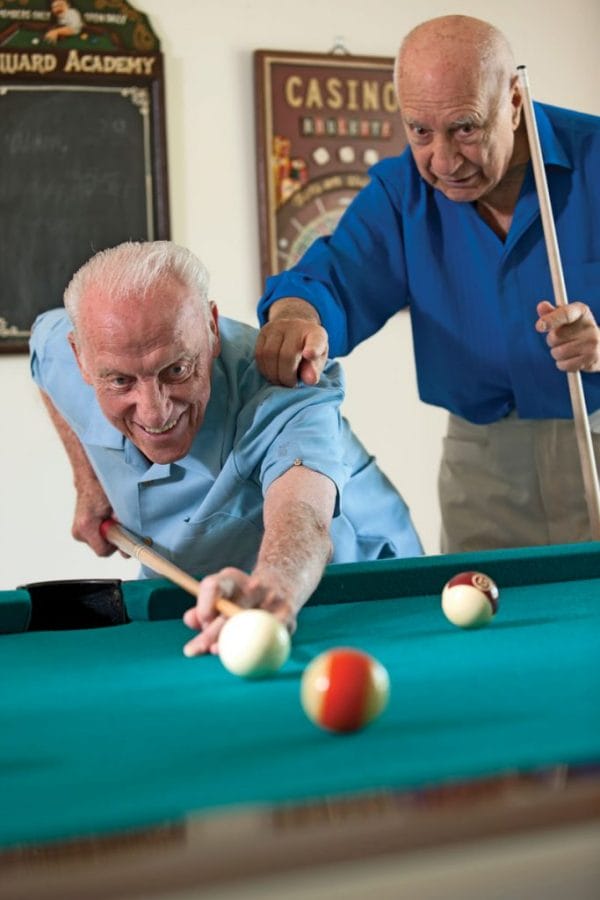 Abbey Delray North male residents playing billiards