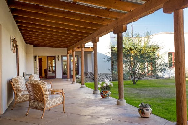 Covered porch overlooking the grounds of The Hacienda at The River