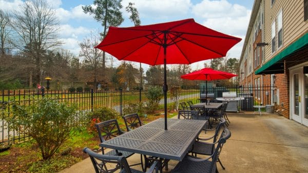 Red umbrella table on the Sandston Plateau Senior Retirement Community patio