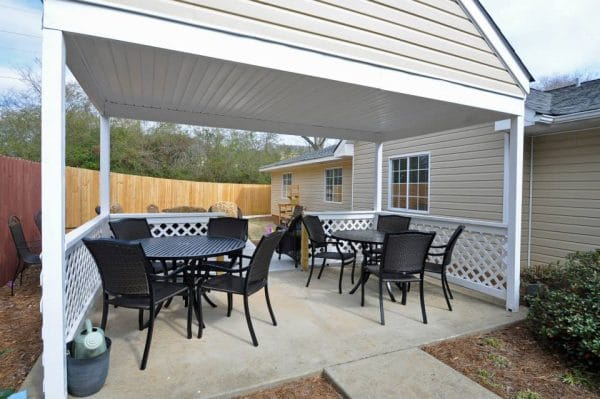 Outdoor dining on the Legacy Ridge at Neese Road covered porch