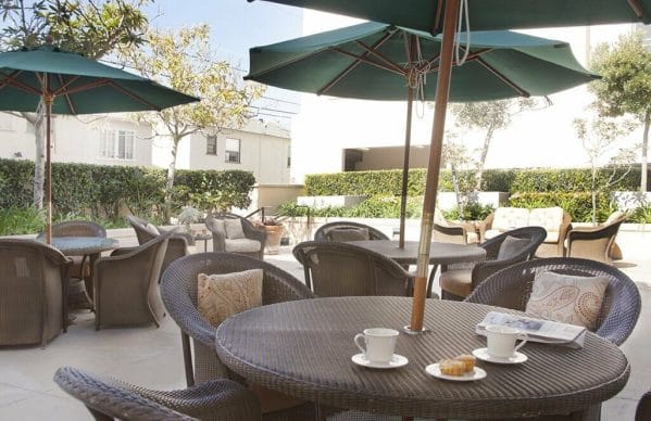 Patio with Outdoor Seating that Includes a Table with Coffee Cups and Muffins at Sunrise of Santa Monica