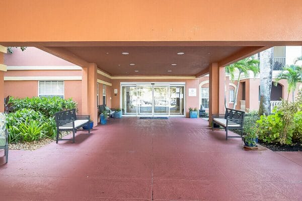 Covered walkway entrance to The Collier at Naples