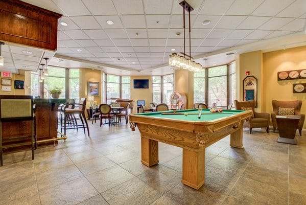 Fountain View Village bar and lounge with a green felt pool table and card tables
