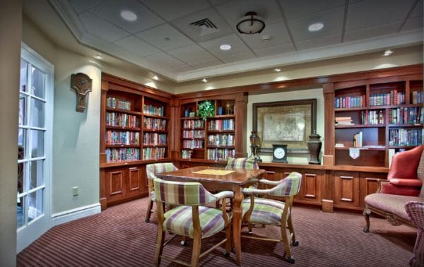 Resident library with built in book cases and 4 top table at The Heritage Tradition