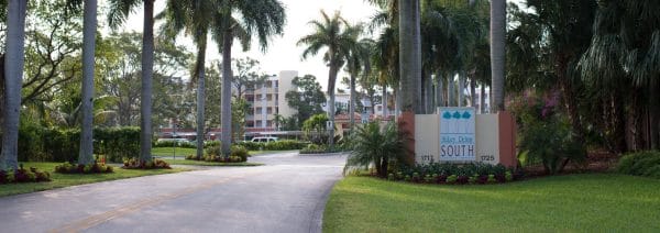 The palm tree lined entrance to Abbey Delray South