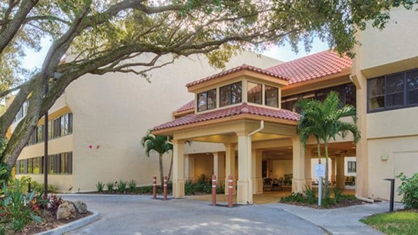 Main entrance with covered area at Arden Courts of Sarasota
