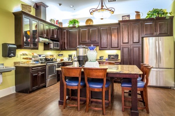 Large gourmet kitchen with granite counters and dark wood cabinets