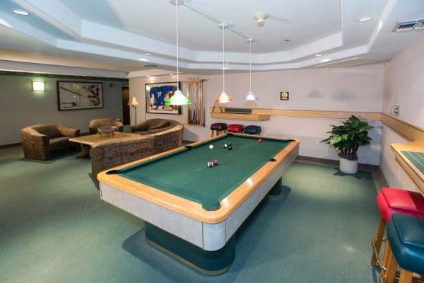 Game room with billiards table in Las Fuentes Resort Village