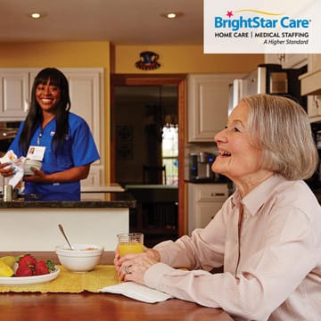 BrightStar Care of Chesapeake caregiver preparin food for elderly woman