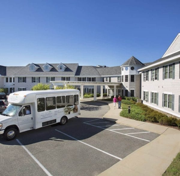 Cape Cod Senior Residences building exterior and community shuttle bus
