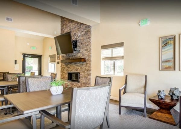 Community Living room with fireplace and large screen tv at Canterbury Court