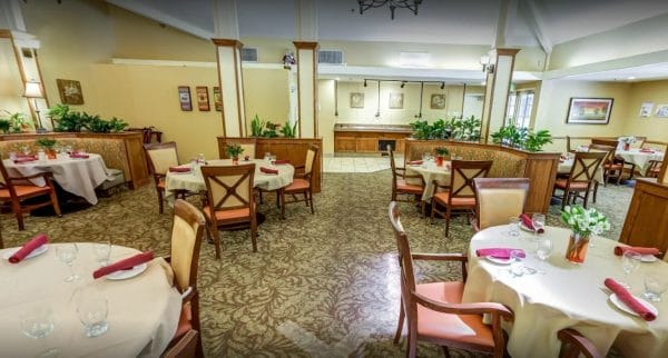 Community dining room at Cypress Court. Includes tables, chairs and booths, formal table settings at Cypress Court