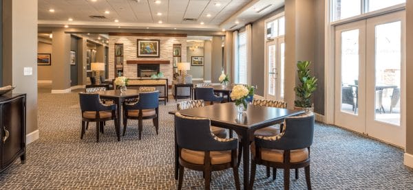 Dining room with plentiful seating and fireplace at Windsor Run