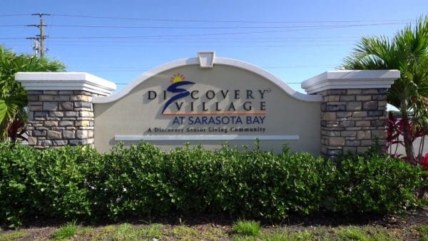 Exterior sign at entrance to Discovery Village At Sarasota Bay