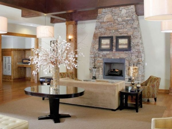 Community living area with sofas and fireplace at Discovery Village At Sugarloaf