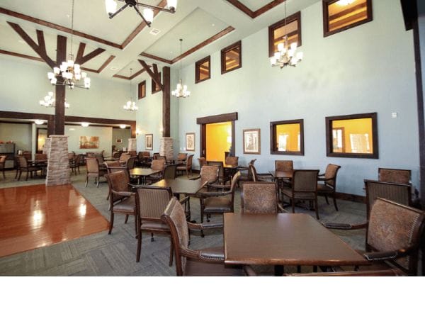 Discovery Village At Twin Creeks main dining room with vaulted ceilings and dark wood features