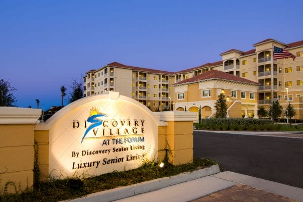 Discovery Village At The Forum - Independent Living main entrance with signage and building in background
