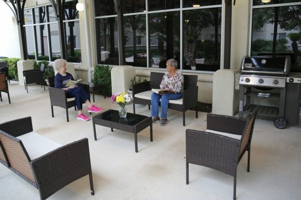 Residents of Esplanade Gardens sitting on the back patio