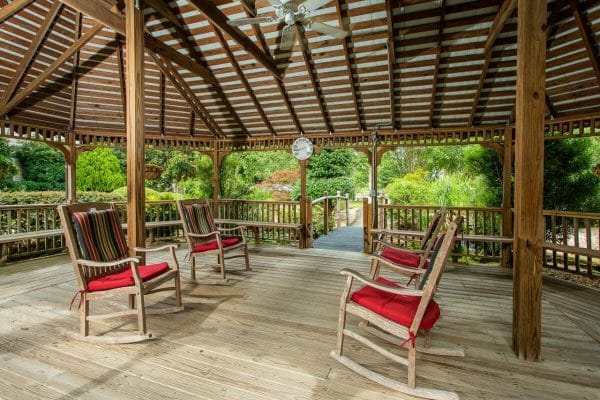 Outdoor seating in rocking chairs in the Veranda of Pensacola gazebo