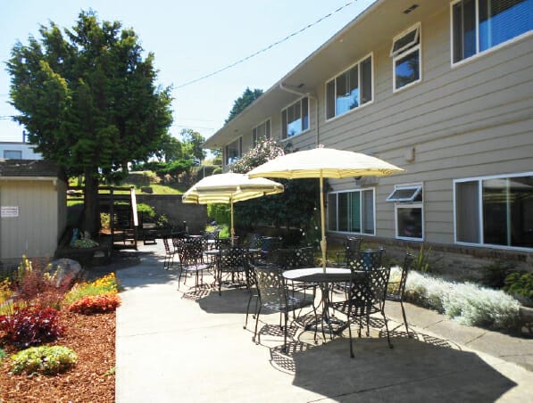 Umbrella covered dining tables on the Grays Harbor patio