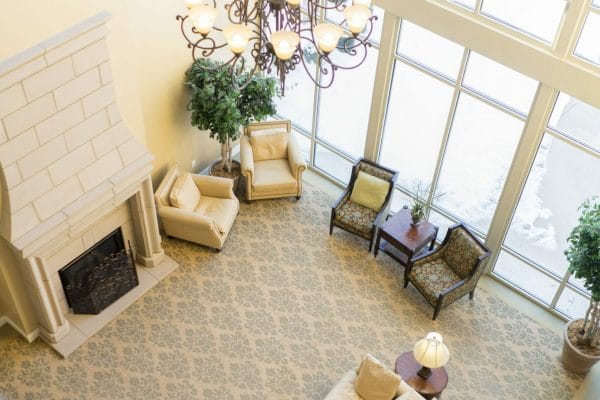 Looking down into the Paramount Senior Living at Bethel Park lobby and common area from the second floor