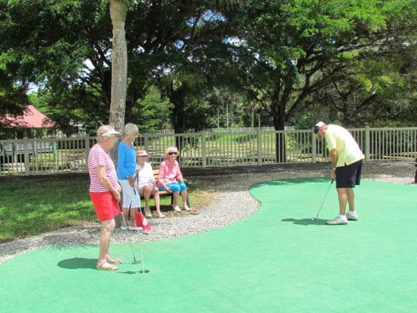 Older ladies and one gentleman on putting green in Florida, Golf, Elderly, putting green
