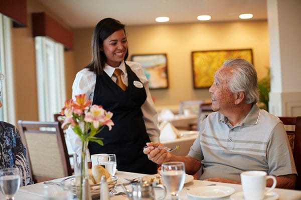 'Ilima at Leihano restaurant server smiling with senior man
