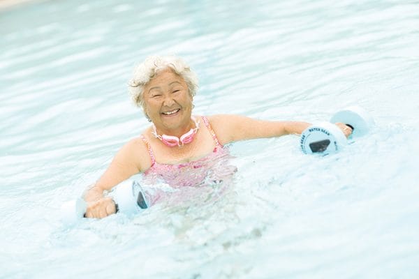 Senior female resident of 'Ilima at Leihano exercising in the pool