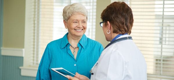 Senior woman smiling at female doctor