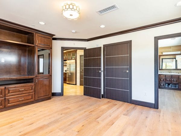 Model living room with hardwood floors and built in cabinets at Hollywood Hills